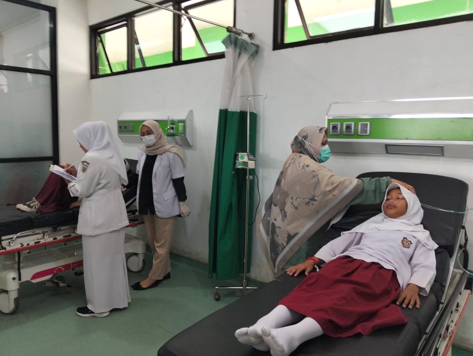 Petugas RUSD Kota Padangpanjang ketika memeriksa kondisi siswa yang diduga mengalami keracunan usai menyantap MBG.